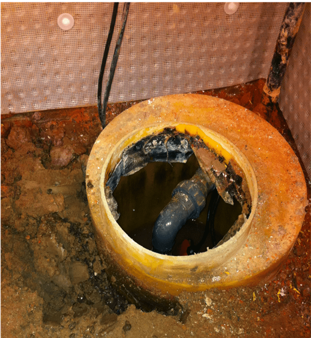 Damaged sump and pump prior to removal