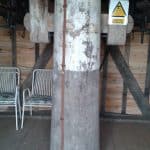 A large metal prop holing up ceiling beam