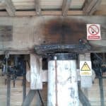 Closeup of a wooden ceiling beam held up with a prop