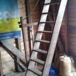 A wooden staircase leading up to loft