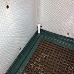 Membrane fitted to a floor and wall. An inspection port is also visible