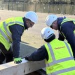 3 technicians wearing PPE working on a wooden beam in Fallowfield for Timberwise Case Study