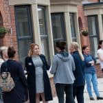 People outside terraced houses in Liverpool
