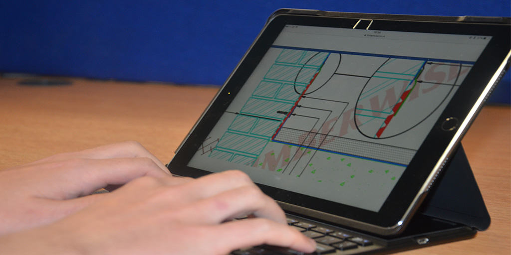 Closeup of surveyor designing a CAD diagram on an iPad