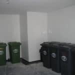 Basement room with bin store with waterproofing white pvc sheets on floor