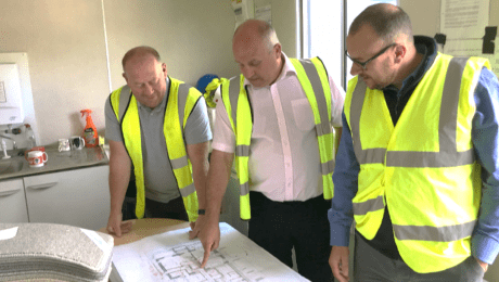 Waterproofing Design Specialists looking at a plan