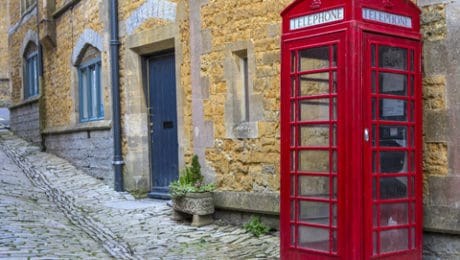 Cobbled street and buildings with old phone box in Castle Cary, Somerset