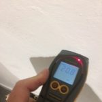 An electronic damp meter on a wall
