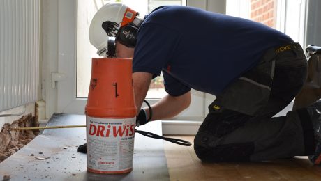 Technician applying a damp proof course