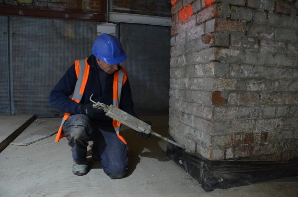 Injecting a damp proof course into a wall