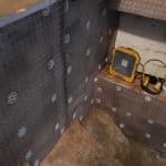 Stairs into a basement with cavity drain membrane fixed to walls Stairs into a basement with cavity drain membrane fixed to walls