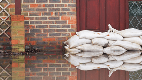 Closeup of sand bags protecting a property from flooding