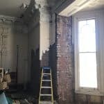 Exposed brick work inside a room with a high ceiling Exposed brick work inside a room with a high ceiling