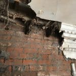 Damaged plaster work showing exposed brickwork Damaged plaster work showing exposed brickwork