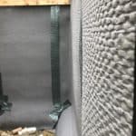 Closeup of basement waterproofing membrane installed on exterior wall