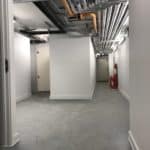 Finished basement hallway in Liverpool after waterproofing installed