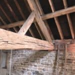 Timber ceiling beam with signs of woodworm