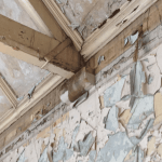 Damaged ceiling beams and flaking wallpaper in St Michaels college