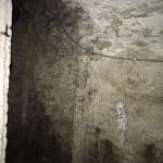 Damp entrance to a basement with an arched ceiling