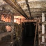 Damaged timbers in a poorly lit basement Damaged timbers in a poorly lit basement