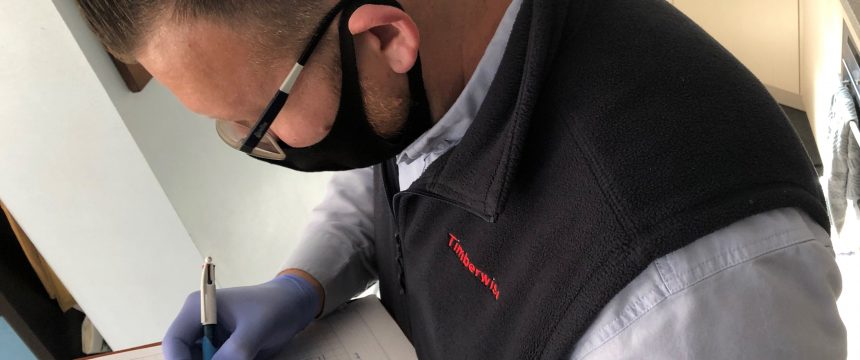 Surveyor carrying out internal wall checks