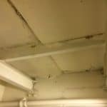 Closeup of ceiling beams in a basement