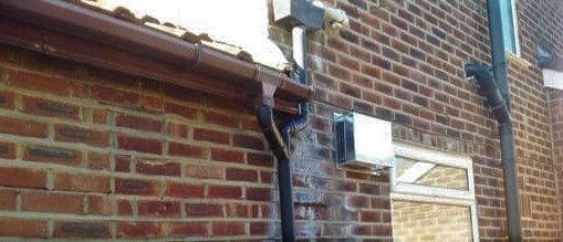 Penetrating damp on exterior brickwork of house from damaged gutters