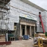 Exterior shot of the outside of the site, large roman like columns to the entrance