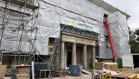 Exterior shot of the outside of the site, large roman like columns to the entrance