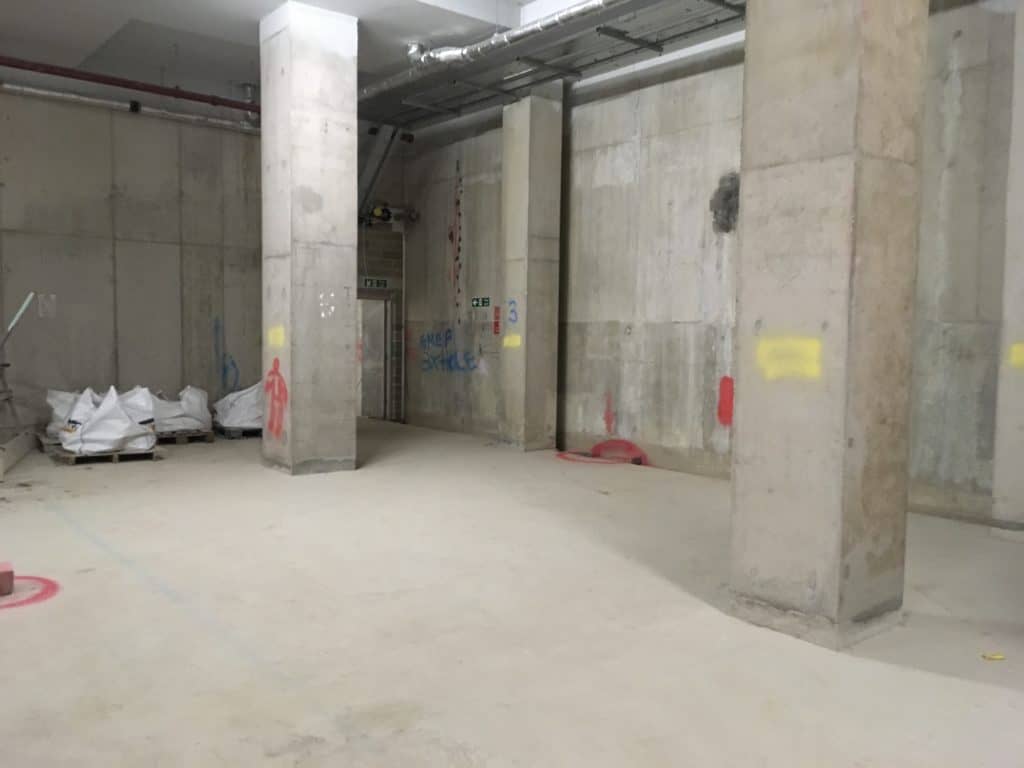 2 concrete pillars in a basement
