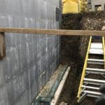 New build exterior wall being prepared for basement waterproofing to be installed