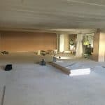 Men working in an empty retail unit Men working in an empty retail unit