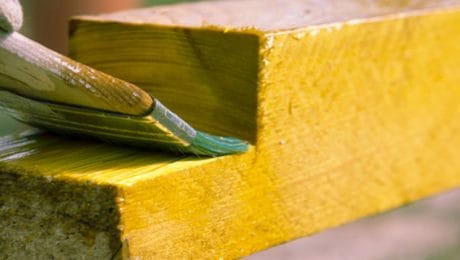 Coating of protection paint being applied to wood against rot