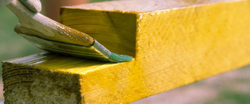 Coating of protection paint being applied to wood against rot