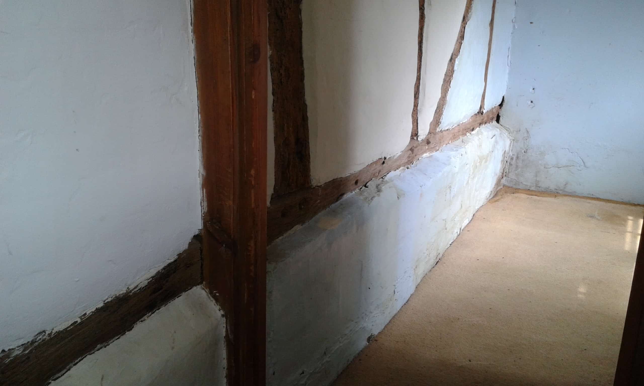 Rising damp on interior wall in cottage