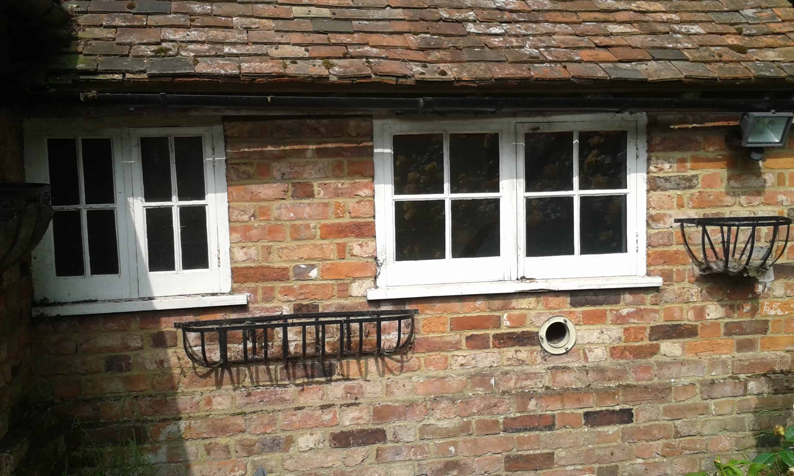 Rising damp on brickwork on exterior wall of cottage
