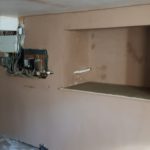 Salop Road - Complete 4 Closeup of Worcestershire basement wall before waterproofing with exposed wiring, electrical box and storage alcove