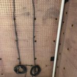 Salop Road - Discharge Pipe Closeup of waterproofing membrane fitted to wall with wiring and pipework in Worcestershire basement