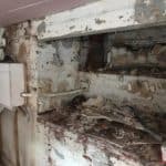 Salop Road - Strip Out 1 Walls in alcove in Worcestershire basement being stripped ready for waterproofing and electrical box on wall