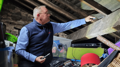 Surveyor Checking Timber Beam In Loft