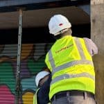 2 technicians wearing PPE working on a wooden beam in Fallowfield for Timberwise Case Study
