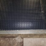 Closeup of black waterproofing membrane applied to a floor