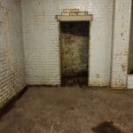 Damp basement with exposed brickwork