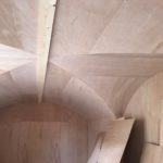 The basement with the wooden cladding applied to walls and moves Closeup of basement with wooden cladding applied to ceiling