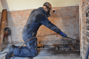 Man treating timbers for woodworm