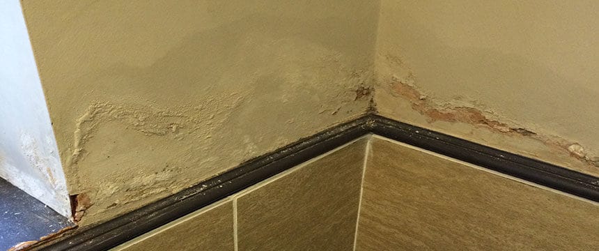 Damp marks forming on bathroom wall
