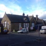 Vehicles parked outside of an old building Vehicles parked outside of an old building