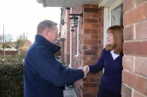 Male surveyor meeting a homeowner on the doorstep