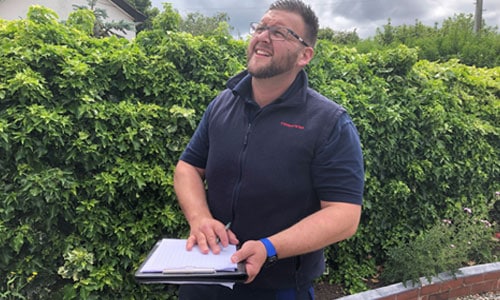 surveyor carrying out damp survey Surveyor with a checkboard carrying out damp survey