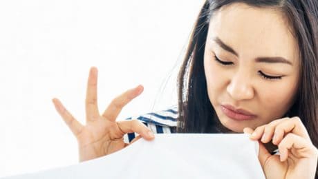 Woman smelling a musty smell in house